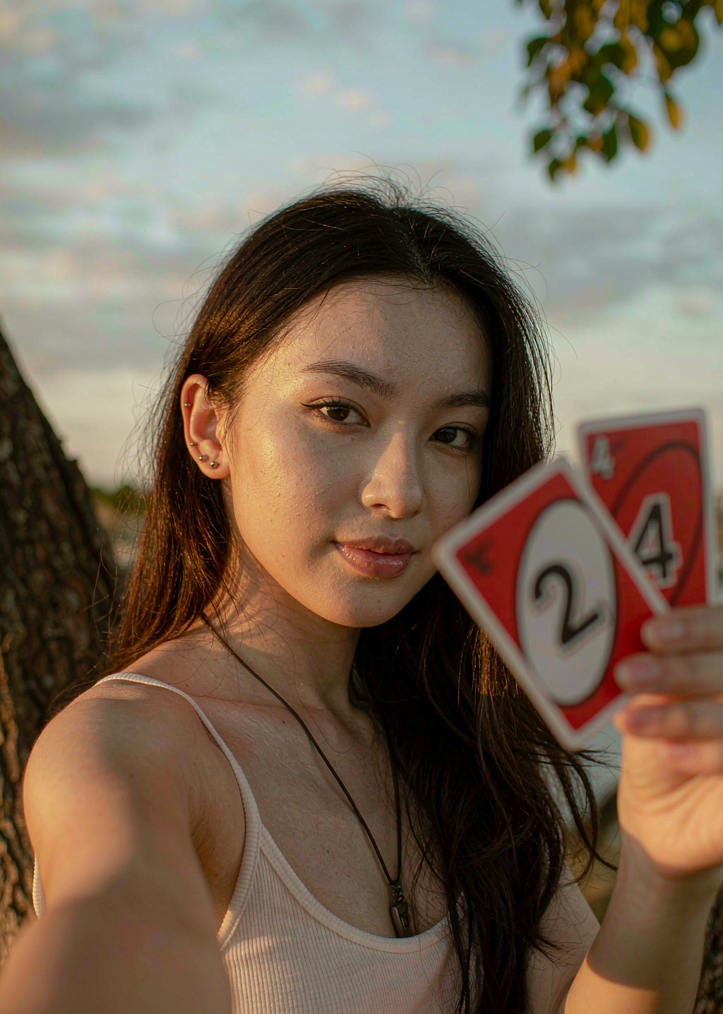 Before — holding the red 2 and 4 UNO cards